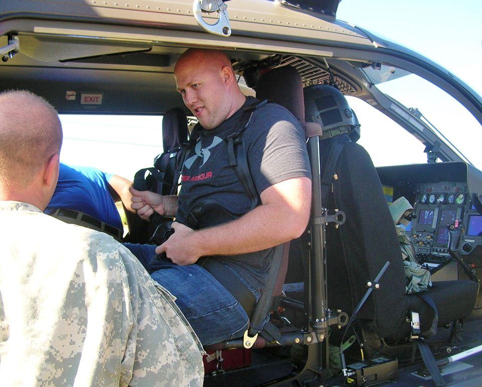 A member of the Sheriff's Office buckling himself into the helicopter.